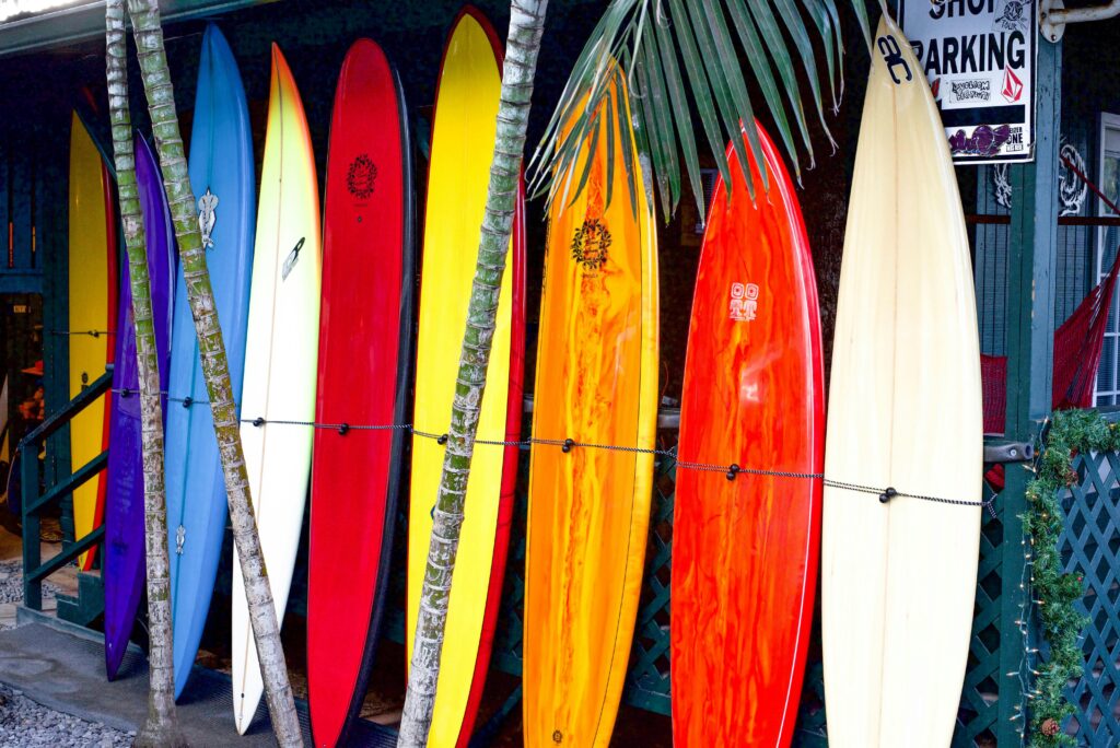 Vibrant surfboards on display at a surf shop in Haleiwa, Hawaii, showcasing tropical colors.
